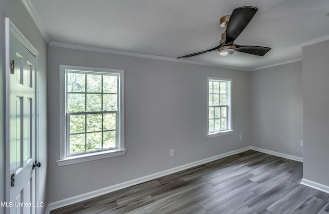 empty room featuring crown molding, ceiling fan, dark hardwood / wood-style floors, and plenty of natural light