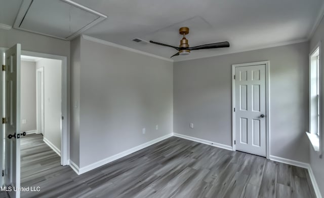 empty room featuring crown molding, hardwood / wood-style flooring, and ceiling fan