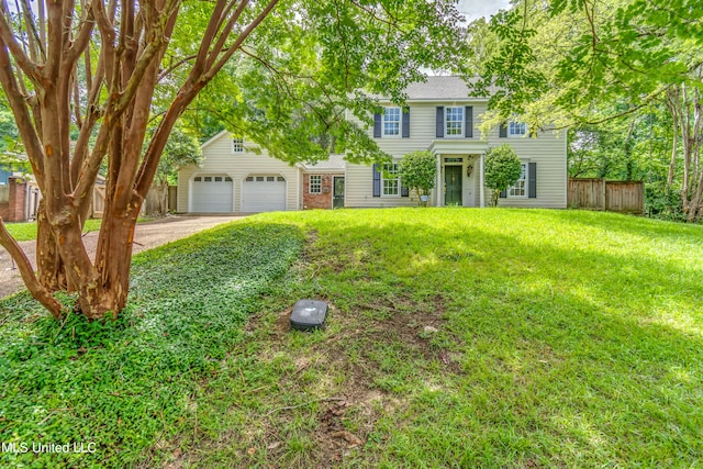 view of front of property featuring a garage and a front lawn