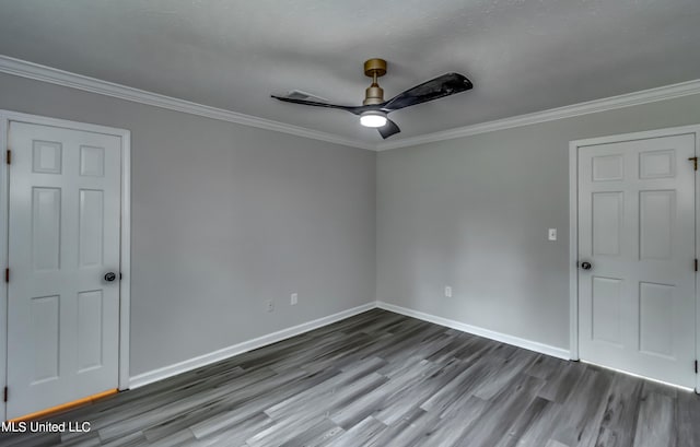 spare room with crown molding, wood-type flooring, and ceiling fan