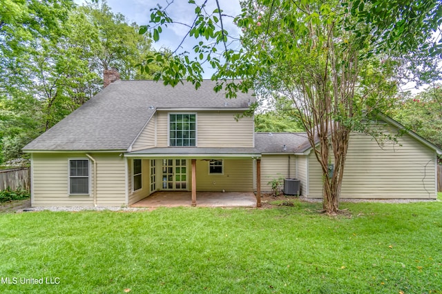 rear view of property featuring a patio area and a yard