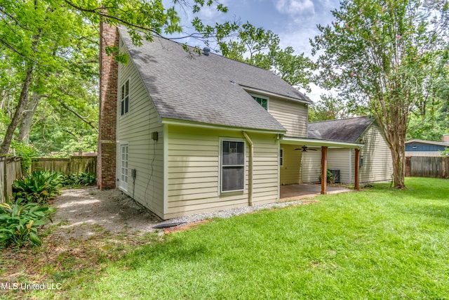 rear view of property with a yard and a patio area