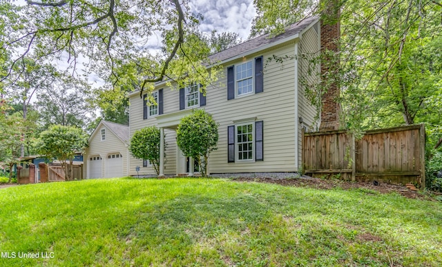 view of front of property with a front lawn and a garage