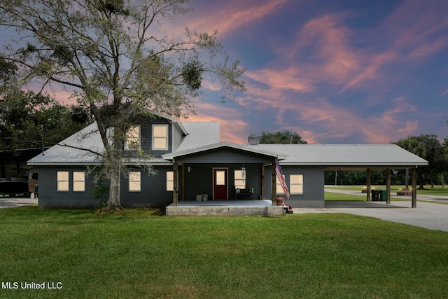 view of front facade with a yard and a carport