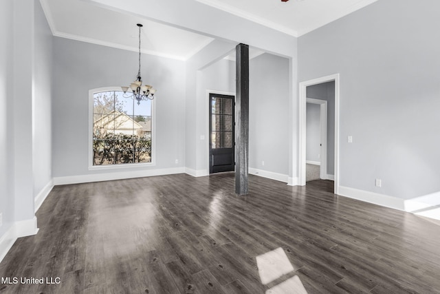 unfurnished dining area featuring dark wood-style flooring, a notable chandelier, and baseboards