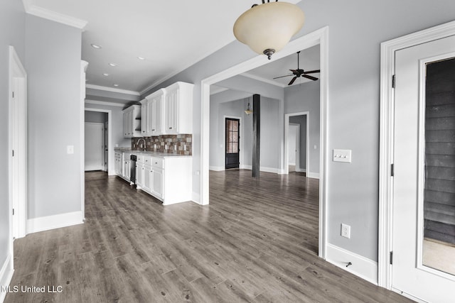 kitchen featuring light countertops, decorative backsplash, white cabinetry, ceiling fan, and wood finished floors