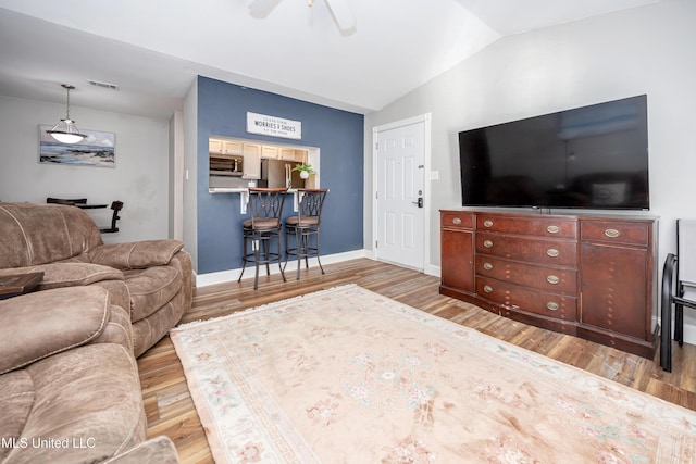 2421 Beachview Dr Unit F16, Ocean Springs, MS 39564 - living area featuring light wood-style flooring, vaulted ceiling, baseboards, visible vents, and ceiling fan