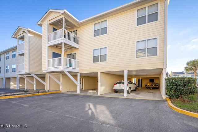 2421 Beachview Dr Unit F16, Ocean Springs, MS 39564 - view of front of property with ceiling fan, a carport, and a balcony