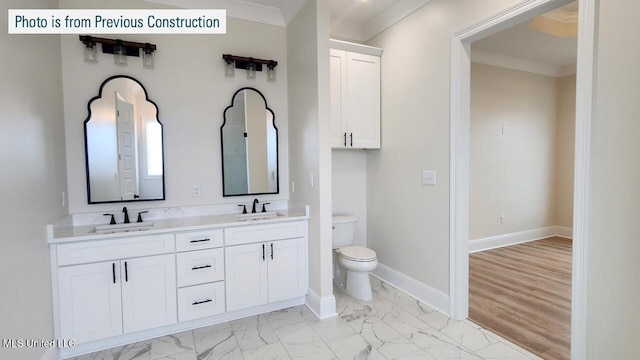 220 W Ave, Long Beach, MS 39560 - bathroom featuring double vanity, marble finish floors, toilet, crown molding, and baseboards