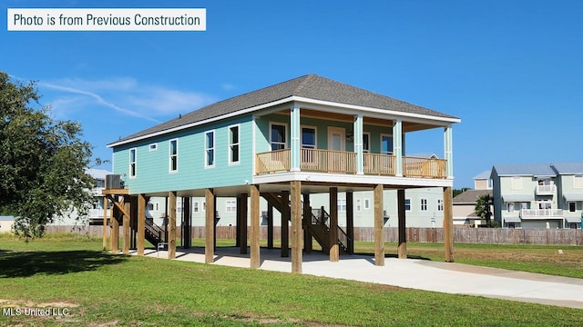 220 W Ave, Long Beach, MS 39560 - back of house featuring stairway, a carport, driveway, roof with shingles, and covered porch