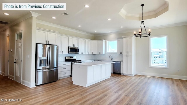 220 W Ave, Long Beach, MS 39560 - kitchen with appliances with stainless steel finishes, crown molding, a sink, a center island, and decorative backsplash
