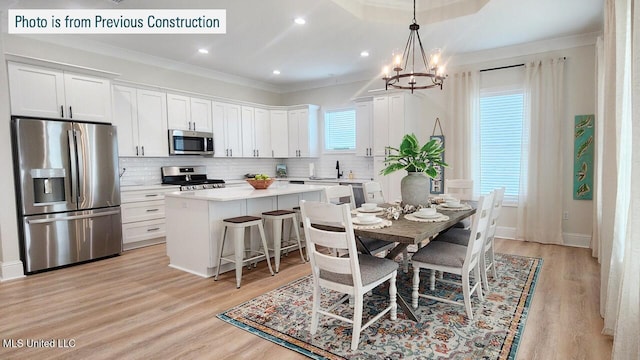 220 W Ave, Long Beach, MS 39560 - dining room featuring a chandelier, crown molding, light wood finished floors, recessed lighting, and baseboards