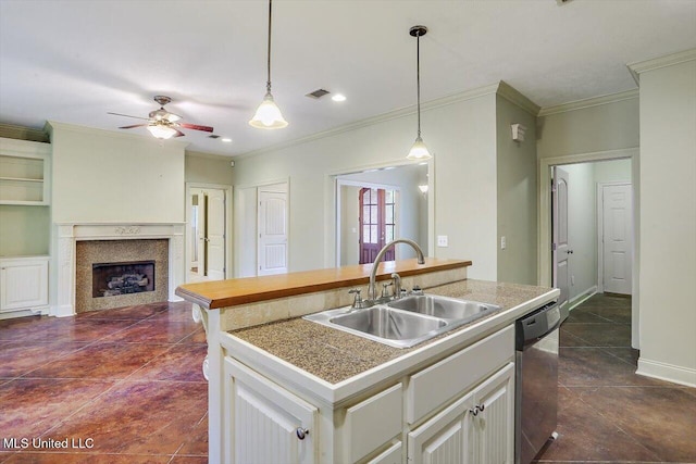 kitchen featuring sink, stainless steel dishwasher, crown molding, an island with sink, and white cabinets