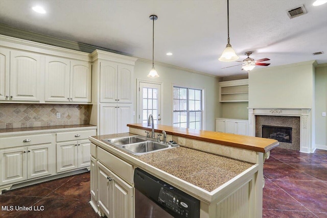 kitchen with tasteful backsplash, stainless steel dishwasher, a kitchen island with sink, crown molding, and sink