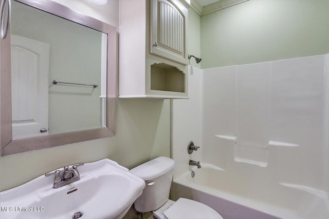 full bathroom featuring sink, tub / shower combination, and toilet