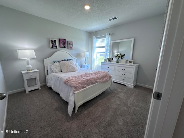 carpeted bedroom featuring a textured ceiling