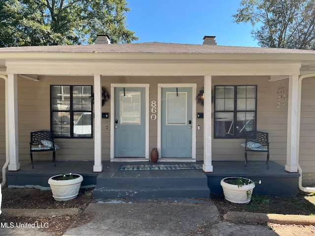 doorway to property featuring covered porch