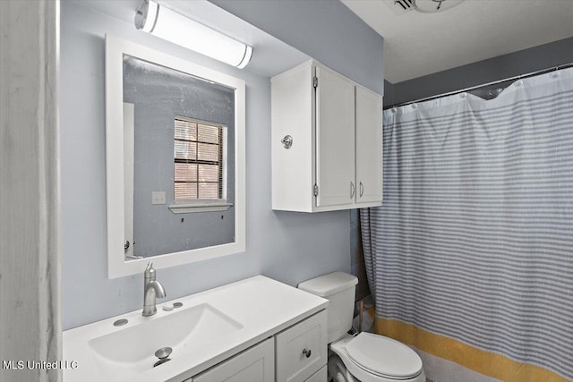 bathroom with vanity, toilet, and a shower with curtain