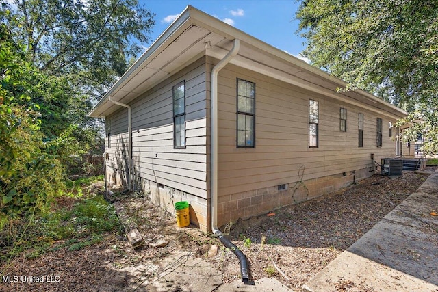 view of side of home with central AC