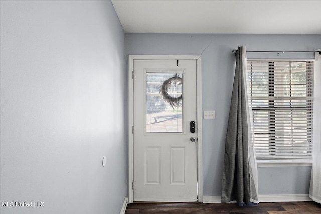 doorway with dark wood-type flooring