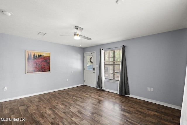 spare room with ceiling fan and dark hardwood / wood-style flooring