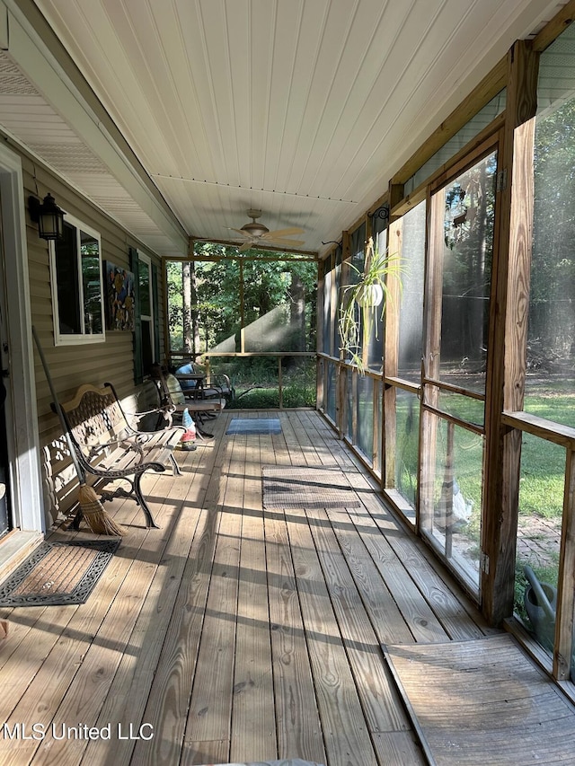 wooden terrace featuring ceiling fan