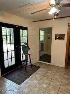 doorway to outside featuring french doors, light tile patterned floors, and ceiling fan