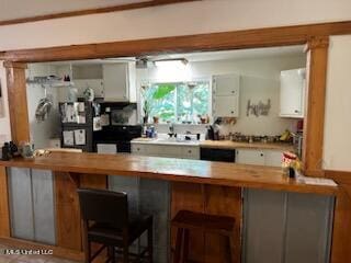 bar featuring white cabinets and dishwasher