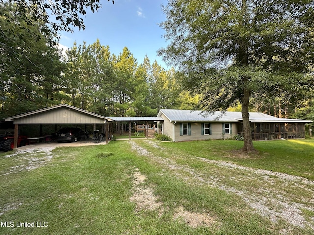 ranch-style house with a front yard, a carport, and a sunroom