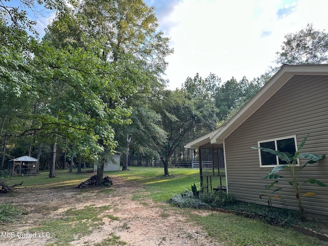 view of yard featuring a sunroom