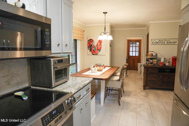 177 Robbins Rd, Brandon, MS 39042 - kitchen with stainless steel appliances, crown molding, a chandelier, decorative backsplash, and decorative light fixtures