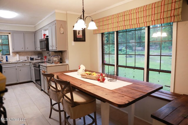 177 Robbins Rd, Brandon, MS 39042 - dining area with a chandelier, crown molding, and light tile patterned floors