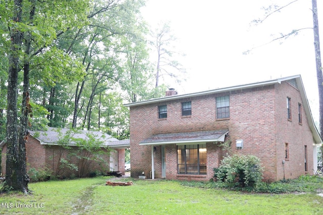 177 Robbins Rd, Brandon, MS 39042 - back of house with a yard, brick siding, and a chimney