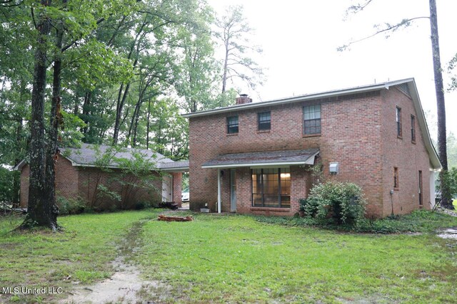 177 Robbins Rd, Brandon, MS 39042 - back of house with a lawn, brick siding, and a chimney