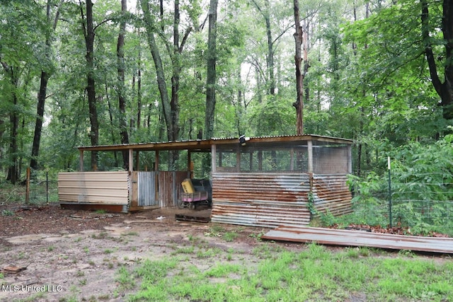 177 Robbins Rd, Brandon, MS 39042 - back of property featuring an outbuilding, exterior structure, and a forest view