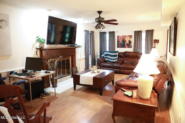 177 Robbins Rd, Brandon, MS 39042 - living area with wood finished floors, a ceiling fan, and a fireplace with flush hearth