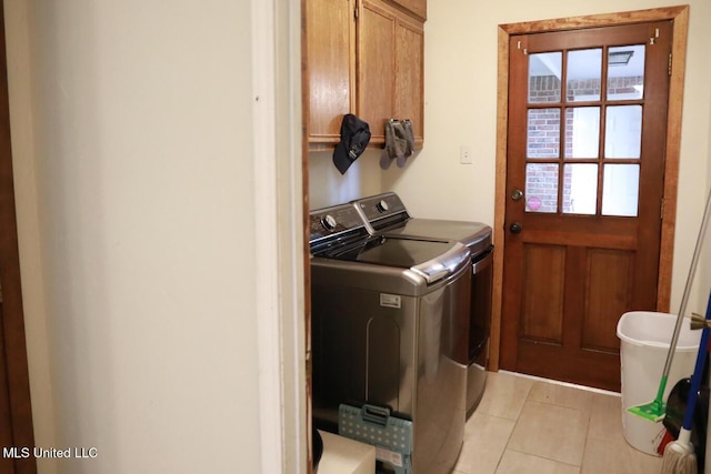 177 Robbins Rd, Brandon, MS 39042 - laundry area with cabinet space, washer and dryer, and light tile patterned floors