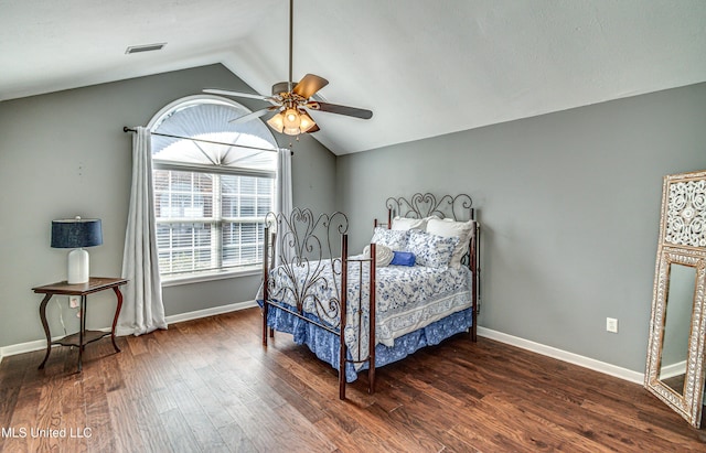 bedroom featuring baseboards, vaulted ceiling, and wood finished floors