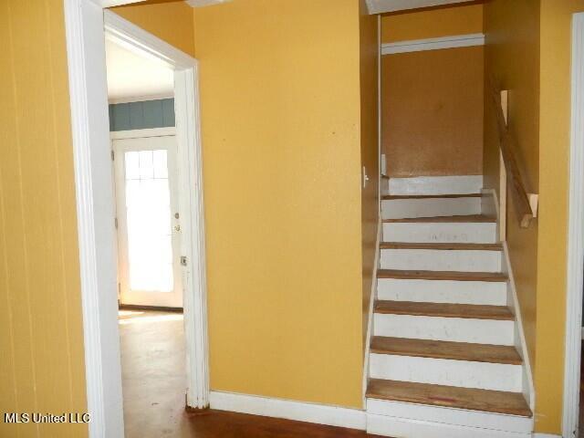stairway featuring baseboards