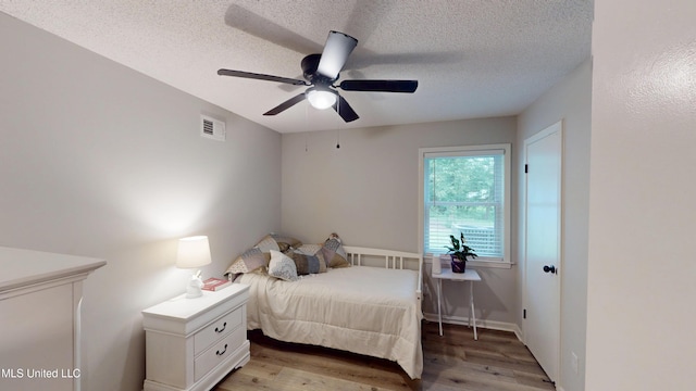 3902 S Windermere Dr, Nesbit, MS 38651 - bedroom featuring light wood finished floors, a textured ceiling, and a ceiling fan
