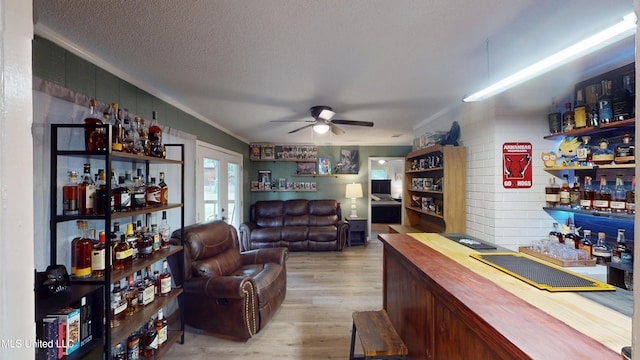 3902 S Windermere Dr, Nesbit, MS 38651 - indoor dry bar featuring a ceiling fan, wood finished floors, a textured ceiling, and crown molding