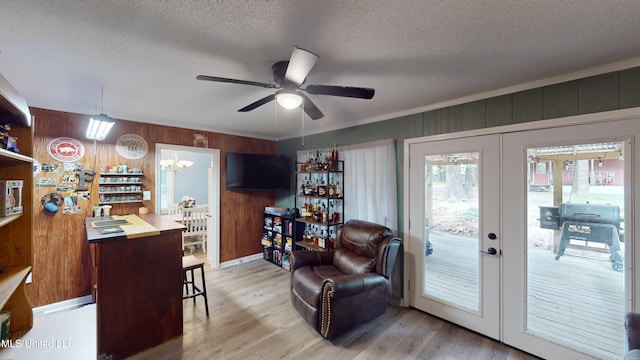 3902 S Windermere Dr, Nesbit, MS 38651 - living area with ceiling fan, a textured ceiling, french doors, light wood-style flooring, and a chandelier