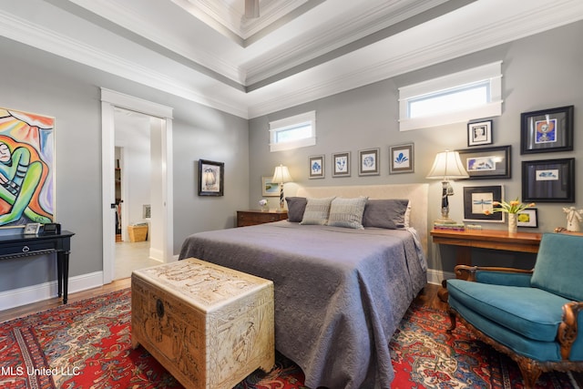 bedroom with wood finished floors, crown molding, and baseboards