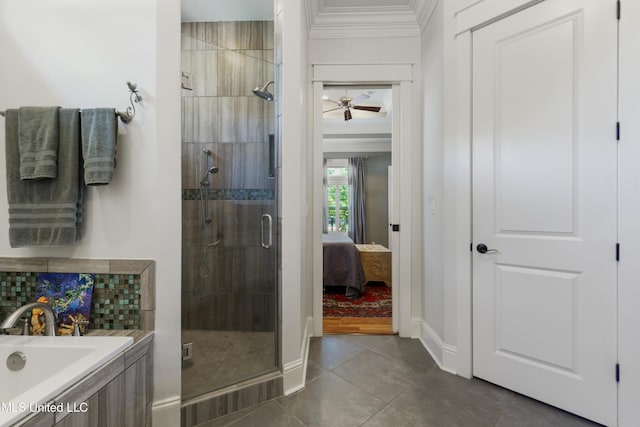 ensuite bathroom with a stall shower, crown molding, tile patterned flooring, a bath, and baseboards