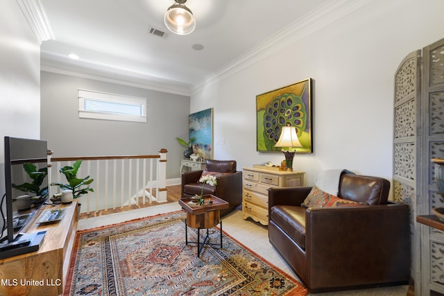 living area featuring ornamental molding and light wood-style flooring