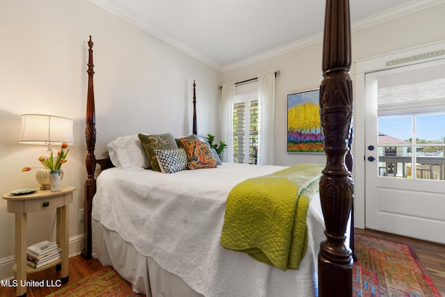 bedroom with wood finished floors, multiple windows, and ornamental molding