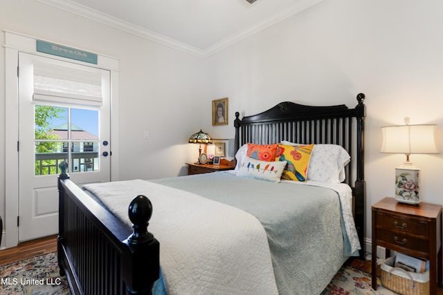 bedroom with crown molding and wood finished floors