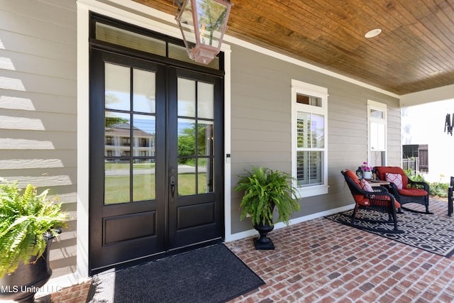 entrance to property with french doors and a porch