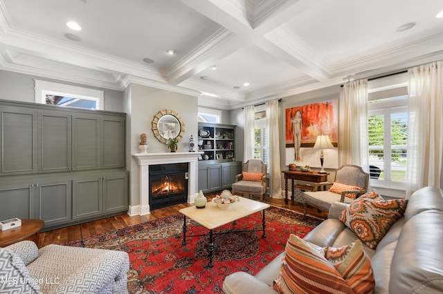 living room with wood finished floors, crown molding, plenty of natural light, beamed ceiling, and a warm lit fireplace