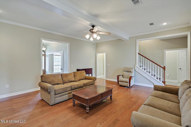 living room featuring crown molding, stairway, baseboards, and wood finished floors